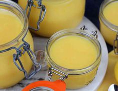 several jars filled with yellow liquid sitting on top of a table