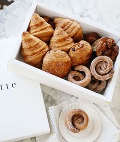 a box filled with pastries sitting on top of a table