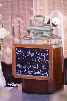 a mason jar filled with ice cream sitting on top of a table next to a chalkboard