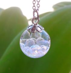 "A magical Resin Orb has beautiful \"Fairy\" Bubbles inside. Each Ball is filled with iridescent Bubbles which when held to the light reflect a few different colors. ❋The ball is 1.5 cm (0.6 inch) diameter ❋Necklace comes with a hypoallergenic Stainless Steel chain. Please choose the chain size when buying. ❋Every piece in this shop was made in several casting steps, sanded and polished by hand. ❋Please note that colours and patterns of each piece may vary slightly as it is unique and individually hand-crafted. Please also allow for  minor imperfections due to handcrafting process and material used. ❋Each finished jewelry listing will arrive ready to gift in a gift box ❋Any questions please feel free to ask :)" Gift Iridescent Crystal Necklace With Round Beads, Iridescent Magical Pendant Necklace, Magical Iridescent Pendant Necklace, Magical Iridescent Necklace Gift, Magical Iridescent Pendant Necklaces, Fairy Globe, Faery Jewelry, Necklace Fairy, Galaxy Pendant