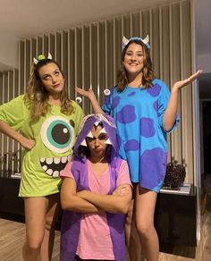 three girls in costumes posing for the camera