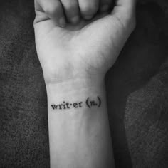 a person with a wrist tattoo that says writer n