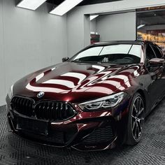 a red car is parked in front of a building with an american flag painted on it