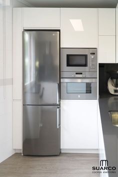 a stainless steel refrigerator freezer sitting inside of a kitchen