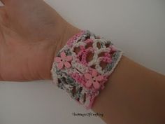 a woman's arm with a crocheted bracelet on it