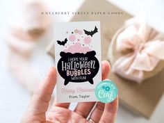 a person holding up a card that says have your halloween bubbles with fun