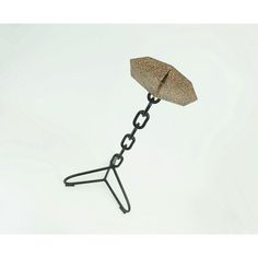 a metal object with a chain attached to it's end and an umbrella shaped like a leaf