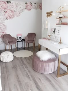 a white room with pink flowers on the wall