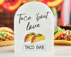 a taco bar sign sitting on top of a table