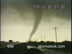 a large tornado is seen in the sky