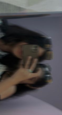 a blurry photo of a person holding a cell phone