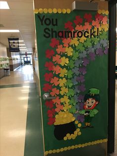 a green door decorated with flowers and a leprechaun