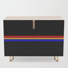 a black cabinet with multicolored stripes on the front and bottom, sitting against a white background