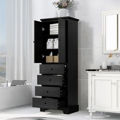 a bathroom with a sink, mirror and black cabinet