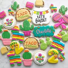 some decorated cookies are on a table with the words let's fiesta written on them