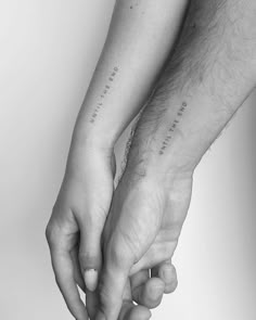 two people holding hands with the words love on them