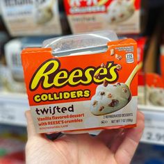 a hand holding up a box of reese's colliders with vanilla flavored desserts