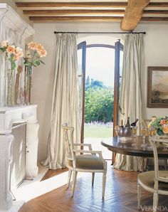 an elegant dining room with french doors leading to the patio