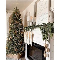 a decorated christmas tree sitting next to a fireplace