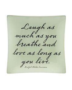 a glass plate with a quote on it that says, laugh as much as you breathe and love as long as you live