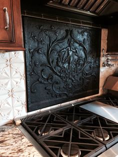 a stove top oven sitting inside of a kitchen next to wooden cupboards and cabinets