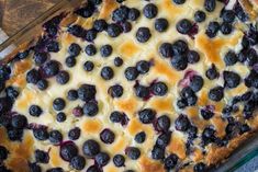 a blueberry cheesecake in a glass baking dish