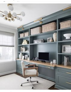 a home office with blue bookcases and white carpet