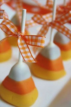 candy lollipops with orange and white stripes tied around them