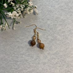 Already Made, ready to ship. Fish hook earring closure on a pendent with 2 rounded Orange and Brown beads as well as gold accent beads. Everything is beads, there are no precious metals. Cheap Brown Dangling Beads Earrings, Gold Beaded Round Earrings, Gold Beaded Round Earrings As Gift, Gold Beaded Earrings Gift, Gold Beaded Earrings For Gift, Gold Beaded Round Earrings For Gift, Round Gold Beads Earrings For Gift, Adjustable Gold Beaded Dangle Earrings, Gift Gold Beaded Earrings