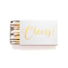 matchesticks with the word cheers written in gold foil on them, sitting next to each other