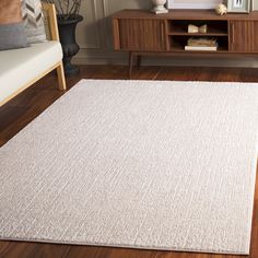 a large white rug in a living room