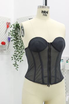 a mannequin with a black corset on it