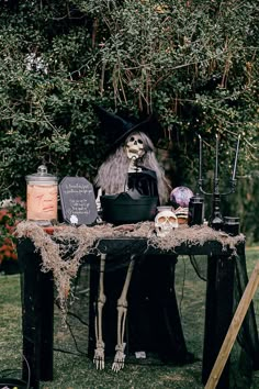 a table topped with halloween decorations on top of a lush green field