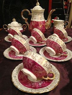 red and white tea set with matching saucers