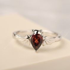 All HANDMADE ITEMS SHIP IN APPROX 8 DAYS Main Stone: Real natural garnet Main Stone Size: Pear cut 5 mm x 7 mm Main Stone Weight: 1.06 carat Side Stone: None Height From The Ring Setting Bottom(to gemstone top): about 4.9 mm Width of Ring band Measure: gradually varied,about 2.14 mm Material: 925 Sterling Silver/14K White Gold/14K Yellow Gold/14k Rose Gold Engraved: Available For FreeNo more than 13 letters) Customized:Of course! Tell me what you want Includes With Order: All of my store items c Vampire Jewelry Ring, Vampire Ring, Blue Topaz Ring Silver, Vampire Wedding, Vampire Jewelry, Bat Ring, Garnet Wedding Rings, Garnet Wedding, Gothic Engagement Ring