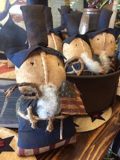 some old fashioned hats are sitting in a potted planter on top of a table