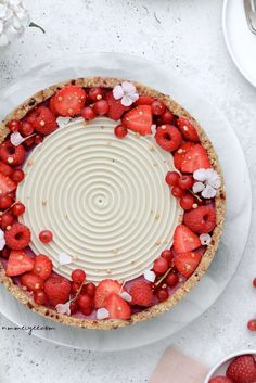 a pie topped with strawberries on top of a white plate