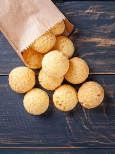 a bag full of biscuits sitting on top of a wooden table