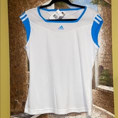 This Is A Truly Pretty T-Shirt! Bright White With The Pretty Adidas Blue Combo. The Logo In The Front Is Raised. The Detail On The Back Is Hot!!! Climacool’s Unique Features With Keep You Dry And Cool, While Looking Ultra Stylish In This Beautiful Top! Size Is L. Moisture-wicking Tennis Tops For Summer, Summer Tennis Tops With Short Sleeves, Summer Short Sleeve Tennis Tops, Short Sleeve Tennis Tops For Summer, Short Sleeve Summer Tennis Tops, Blue Sporty Tops For Tennis, Sporty Blue Tennis Tops, White Tennis Tops For Summer, White Tops For Tennis In Summer