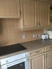 a kitchen with white appliances and wooden cabinets