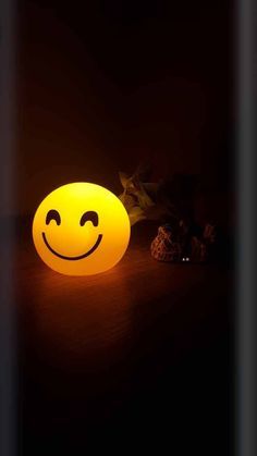 a smiley face light sitting on top of a table