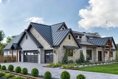 a large house with two garages on the front and one car garage on the back