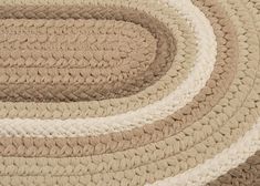 an oval rug is shown in beige and white