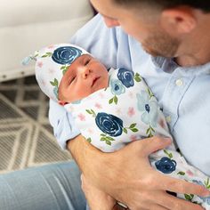 a man holding a baby in his arms