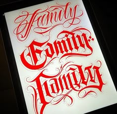 some type of lettering that is red and white with the word family on it in cursive writing