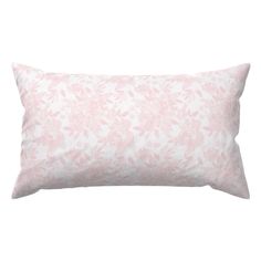 a pink and white floral pillow on a white background