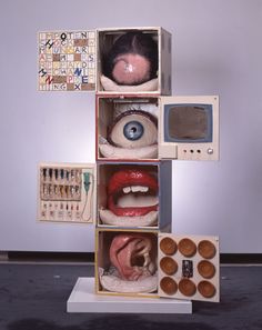 an assortment of fake mouths and eyeballs are displayed in a cubed display case