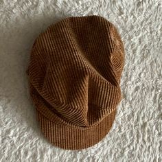 a brown hat laying on top of a white carpet