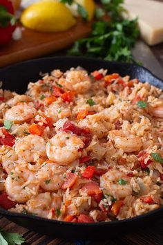 shrimp and rice in a skillet with parsley on the side, ready to be eaten