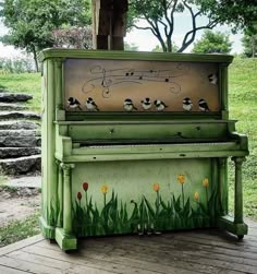 an old piano with birds painted on it